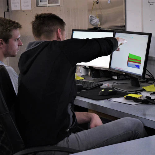 Engineers discussing best route to take to produce carbon fiber part