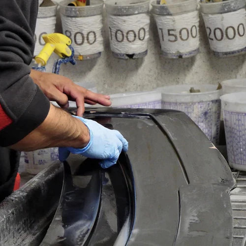 A person finishes laminating a mold