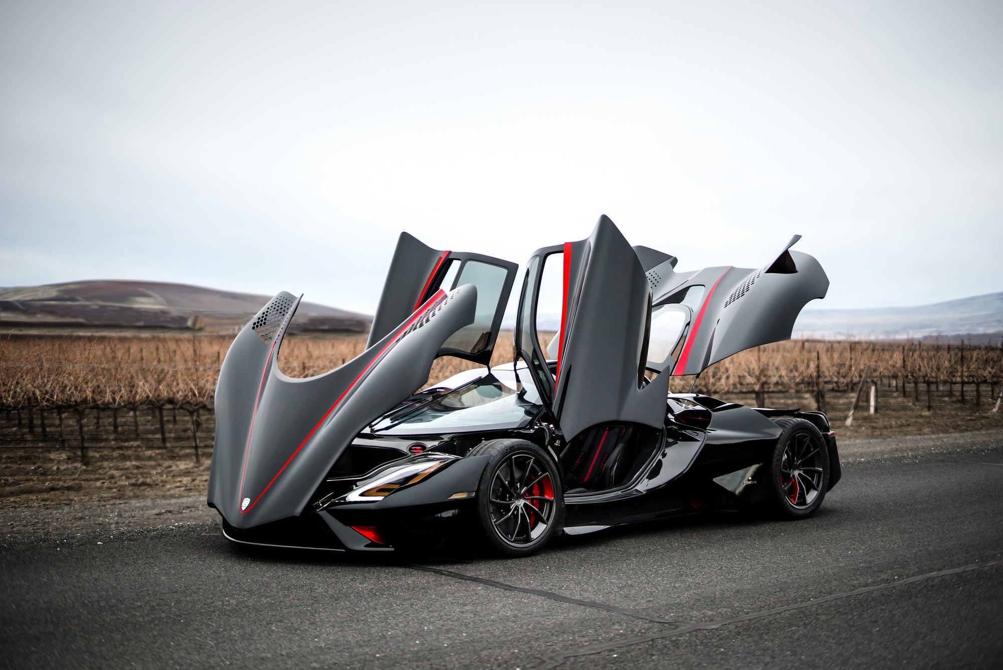 a photo of the tuatara super car with all of its doors, hood, and trunk open