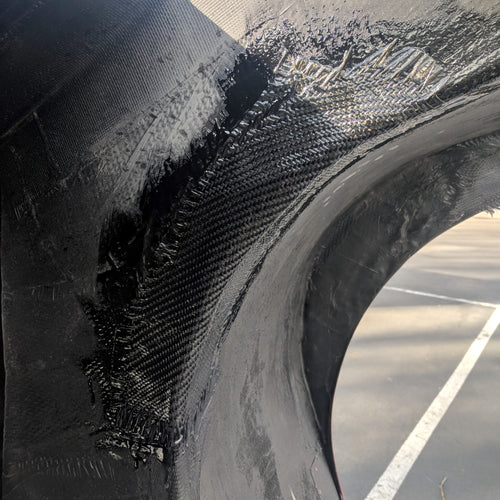 piece of carbon fiber undergoing a wet layup