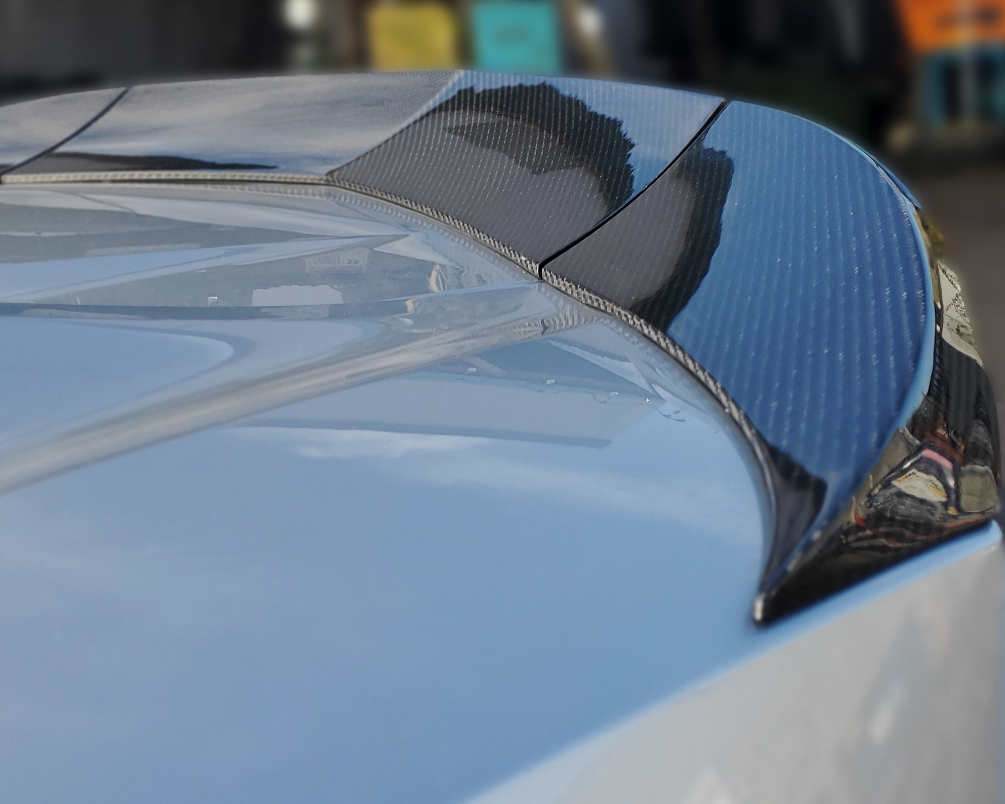a 3 piece carbon fiber spoiler installed on an Acura NSX 