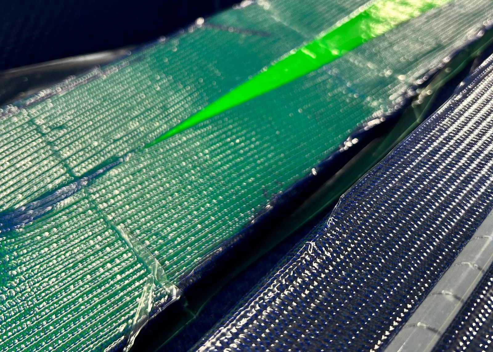 A close up of a carbon fiber resin infusion showing different composite materials