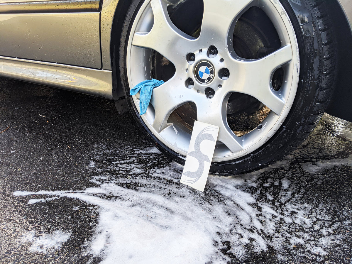 Grey Common Fibers decal next to tire
